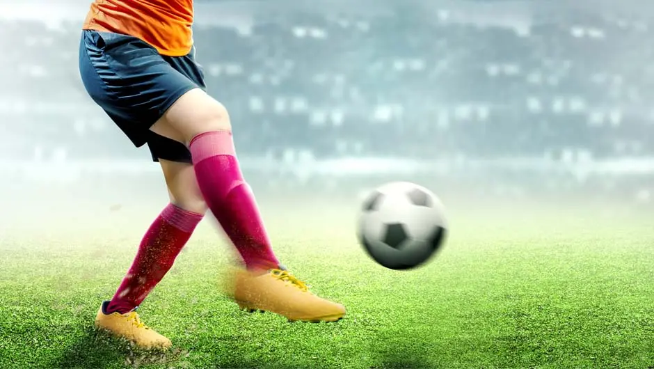 Person som sparkar på en fotboll