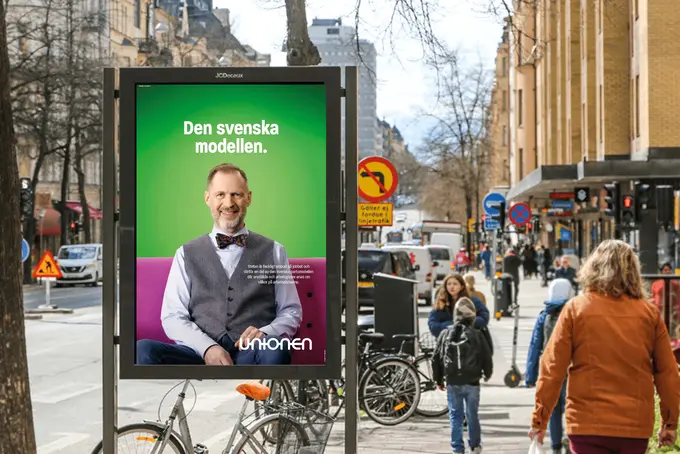 Reklamskylt med fackligt ombud på och rubriken "Den svenska modellen":