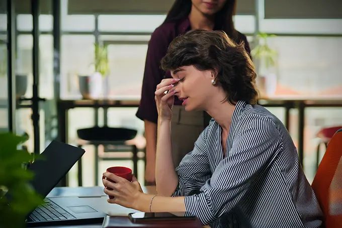 Stressad kvinna vid dator